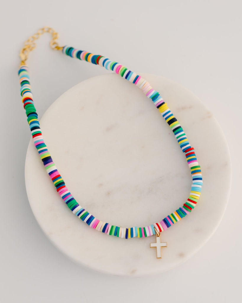 child multicolor heishi bead necklace with white and gold cross charm