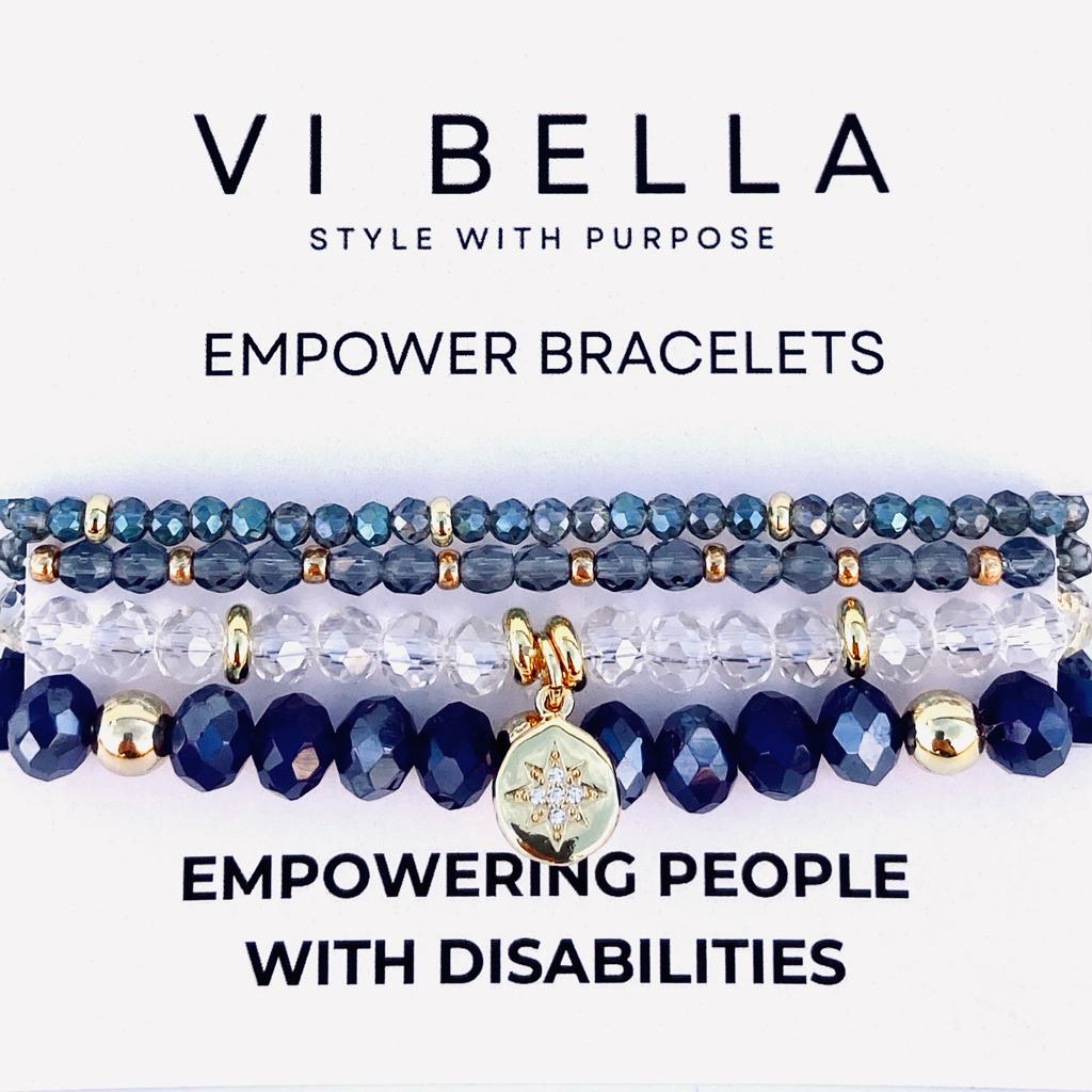 set of four blue and clear beaded bracelets with gold accents empowering those with disabilities