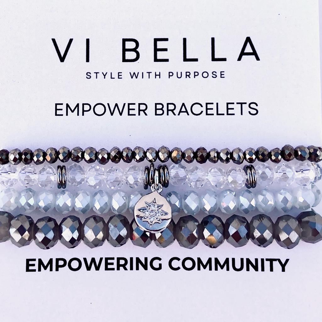 set of four gray and clear beaded bracelets with silver accents empowering community